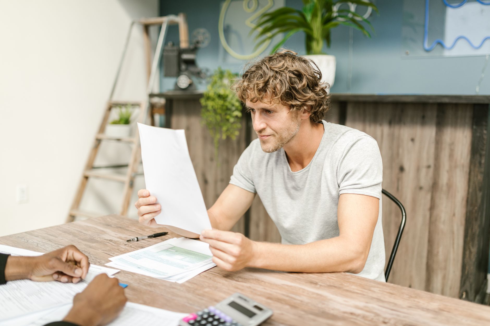 Worker reviewing year-to-date contributions on a pay stub