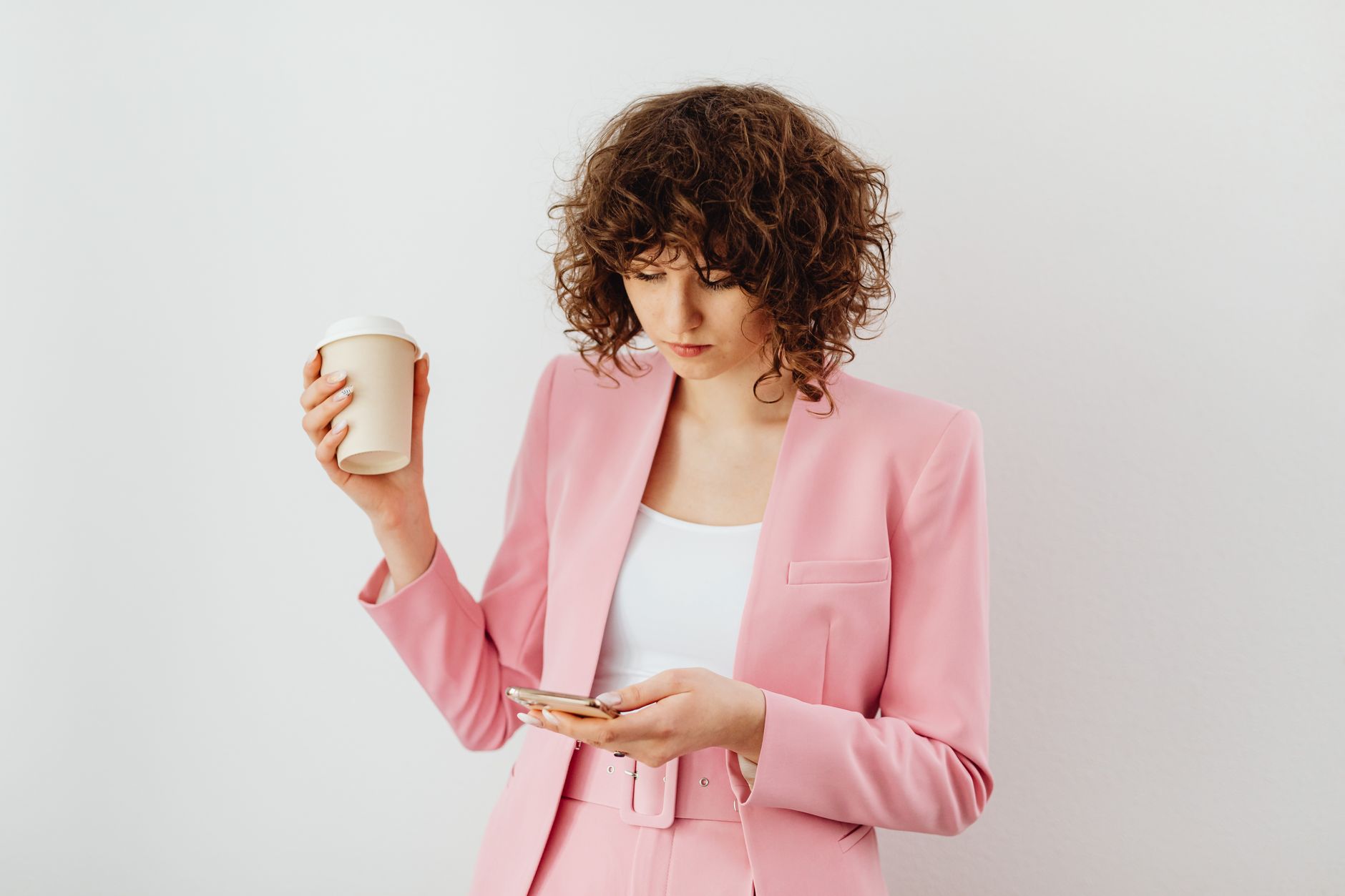 Woman checking her bank balance on her phone before an automatic payment draws