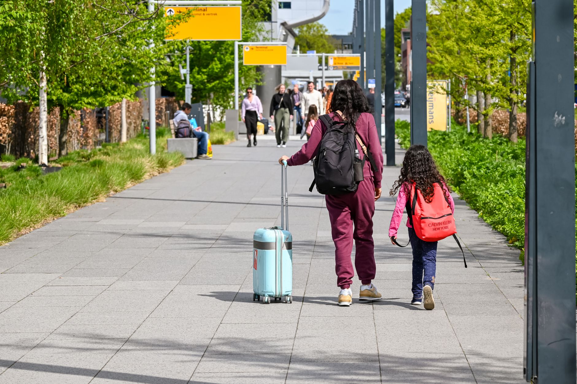Family with luggage at the airport heading out on a summer trip