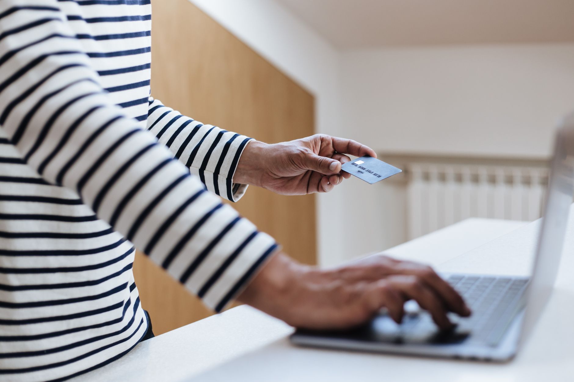 Person paying a credit card balance online before the statement closing date to lower reported utilization