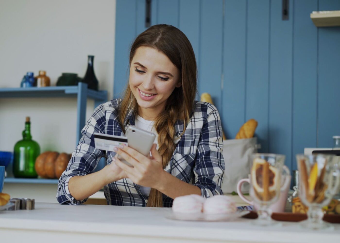Woman checking her credit card statement on her phone after holiday spending