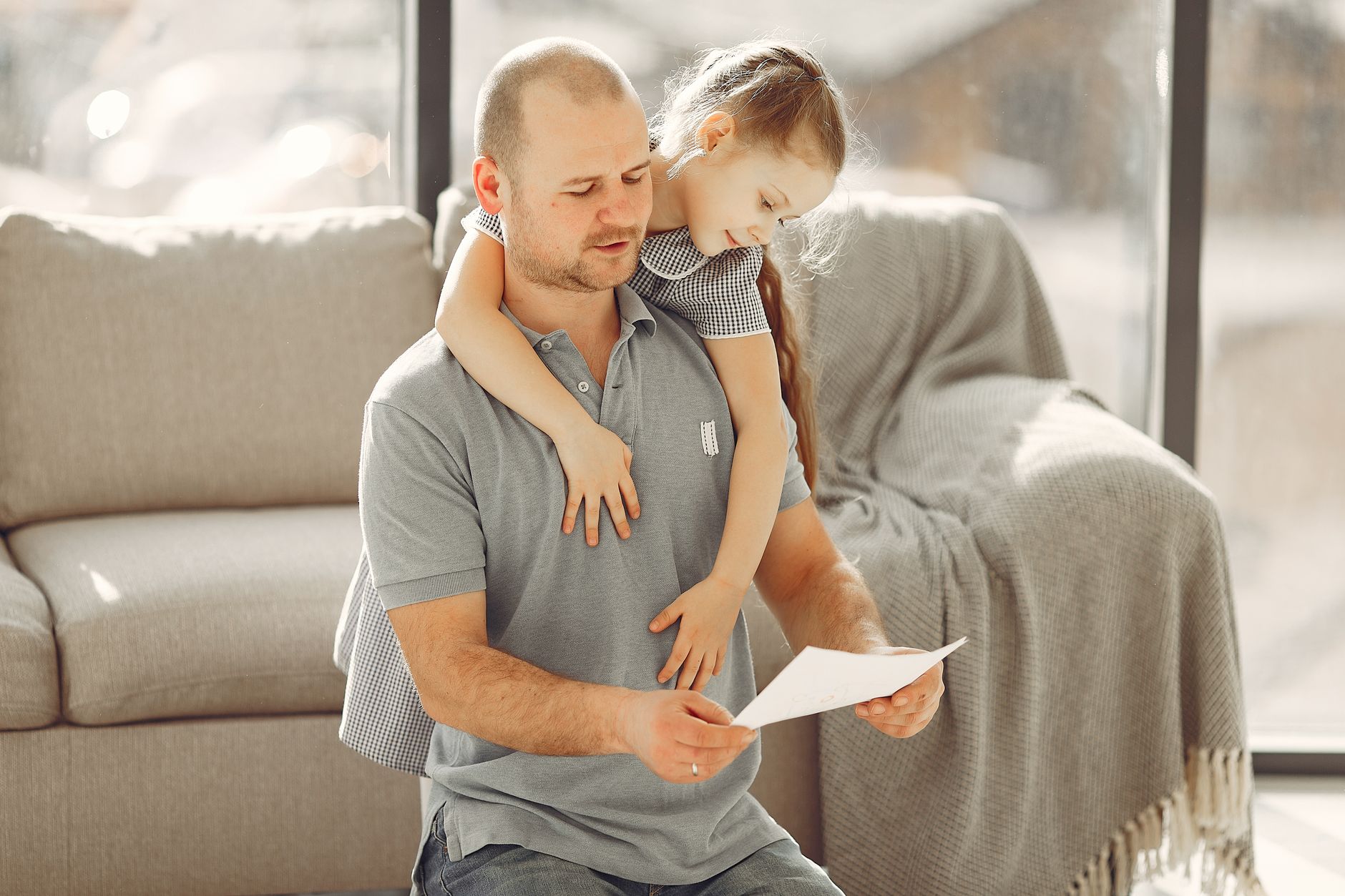 Parent and child going over account paperwork together at the kitchen table