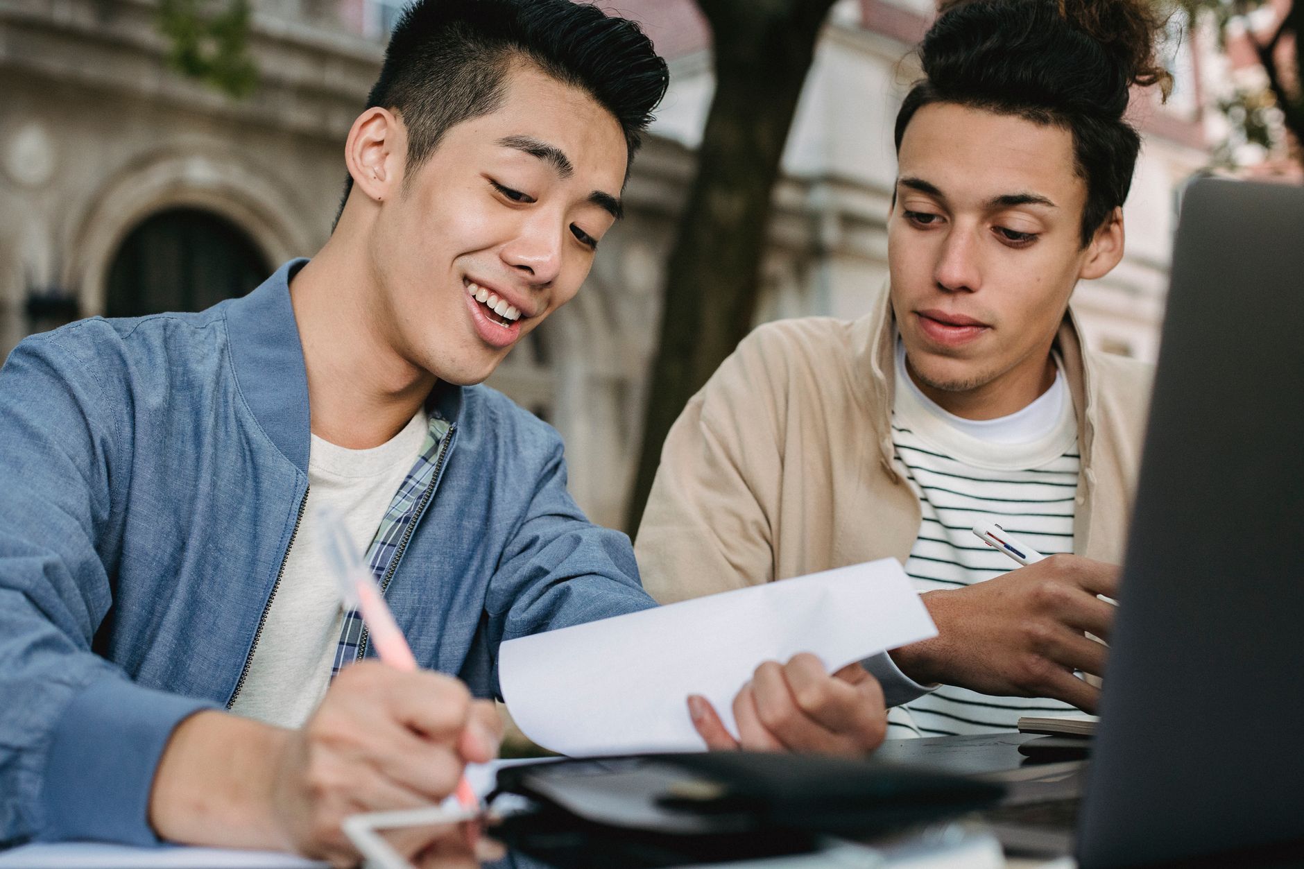Parent and college student reviewing loan paperwork on a laptop