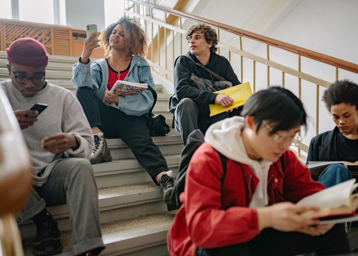 College student checking a bank app on campus as the fall financial aid refund arrives