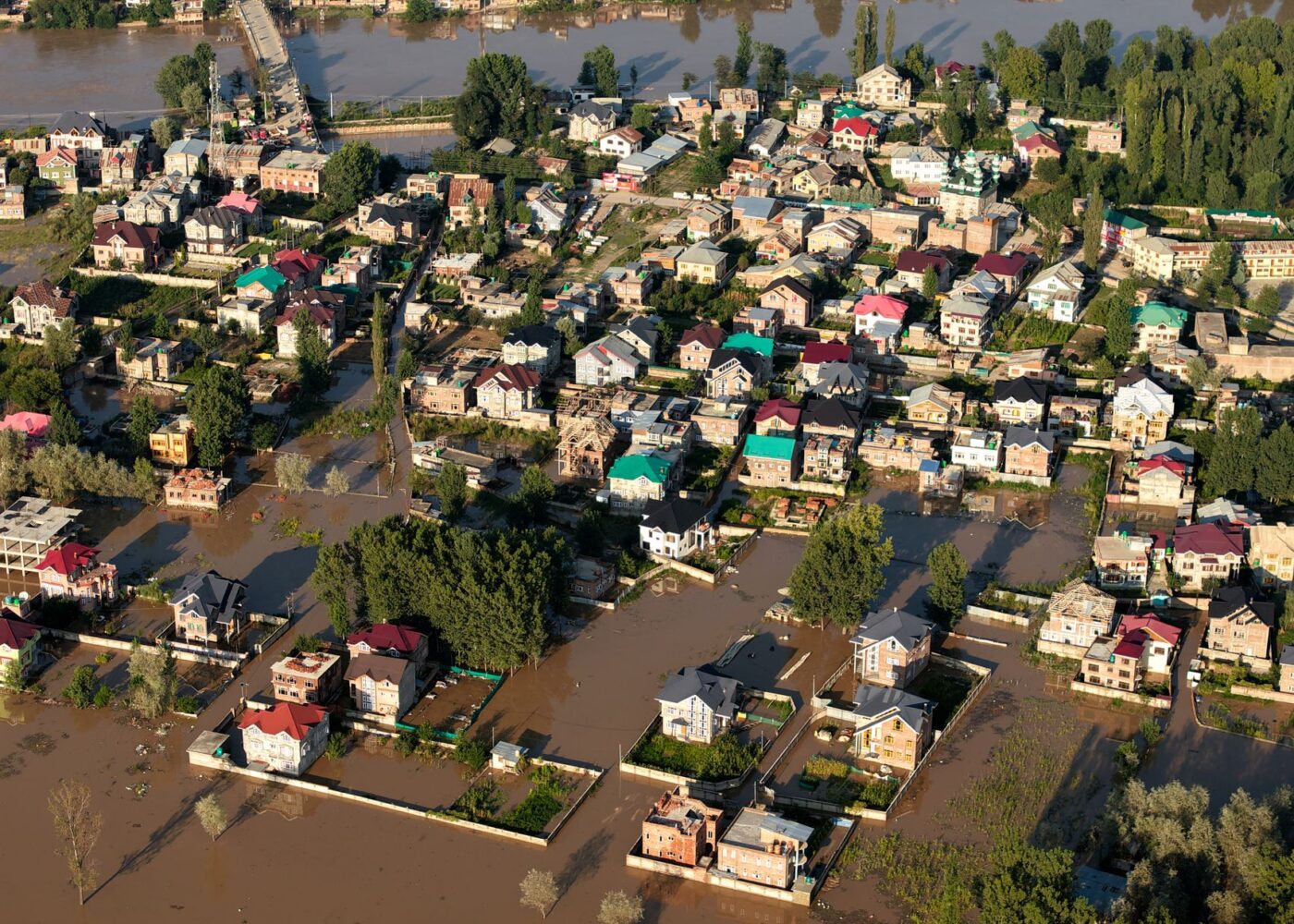 Flooded residential street after heavy rain, the kind of damage homeowners policies exclude