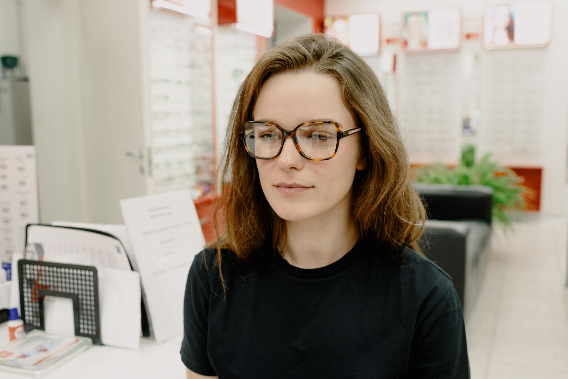 Woman trying on new prescription glasses at an optometrist, a common FSA expense