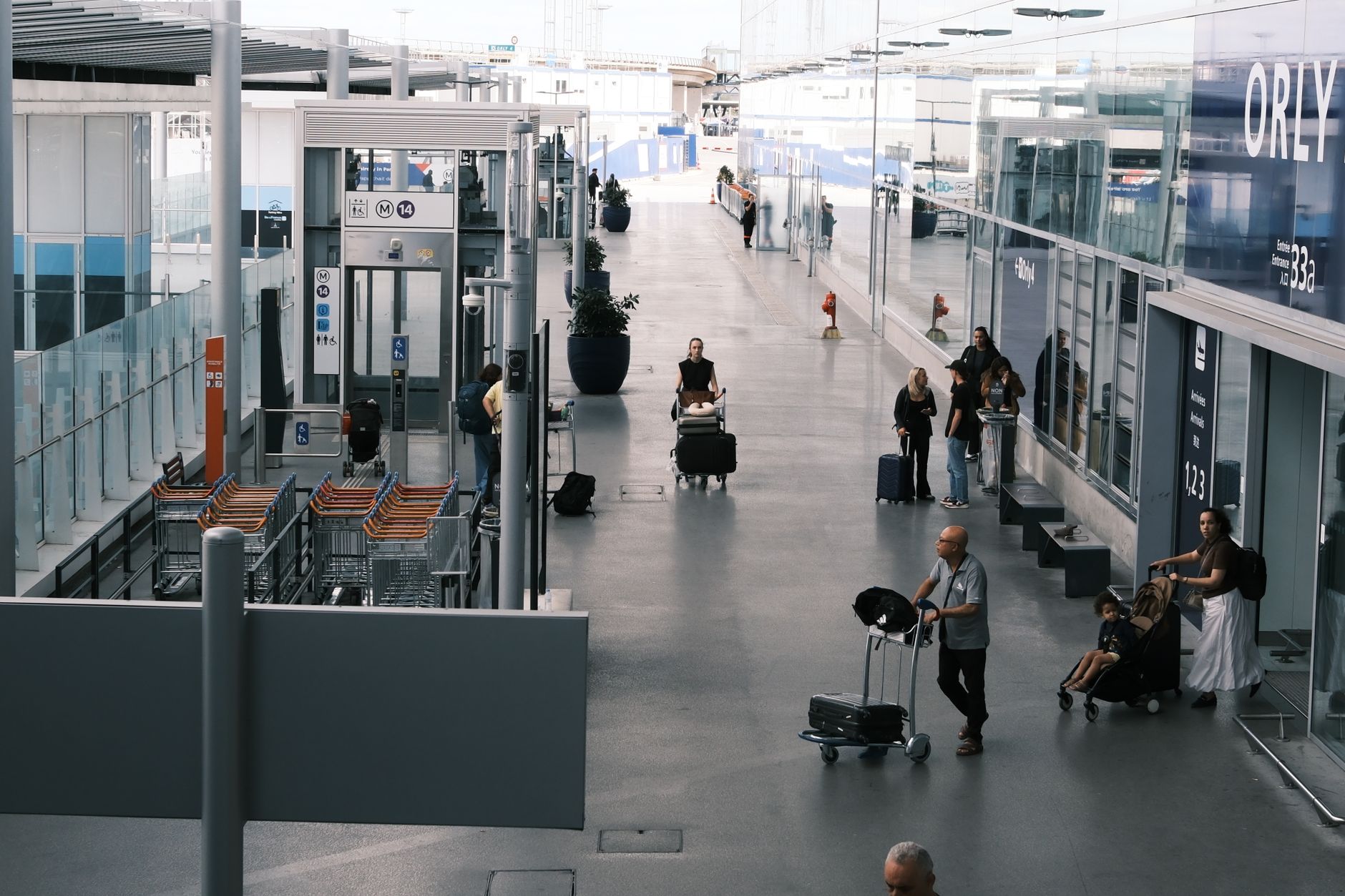 Family checking suitcases at an airport counter before a summer flight