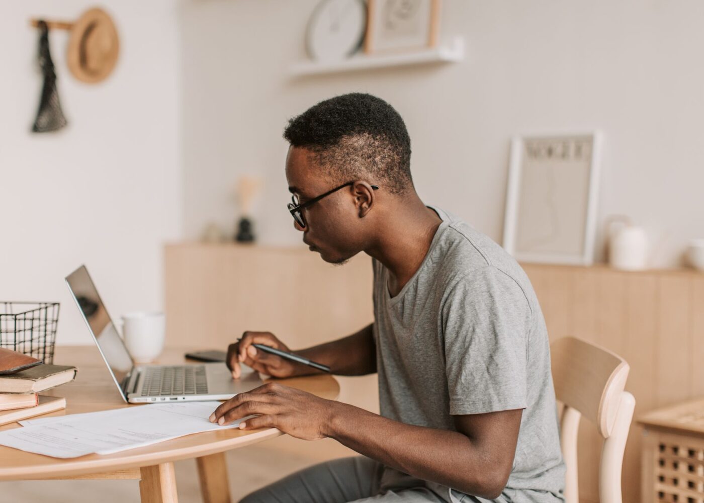 Freelancer with a side business going over quarterly tax paperwork at a home office desk