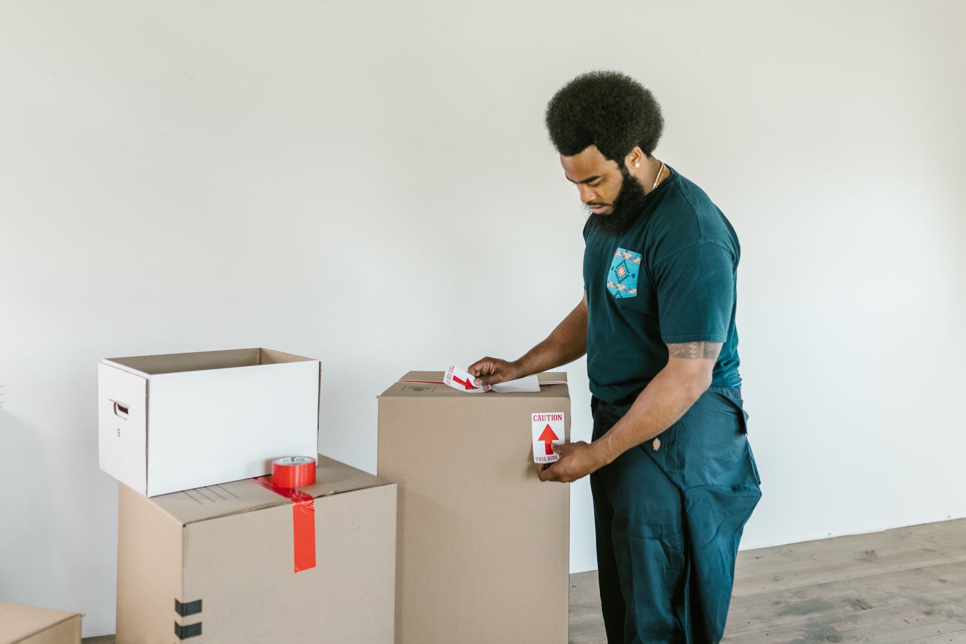 Man taping up a package to send back an online purchase before the return window closes