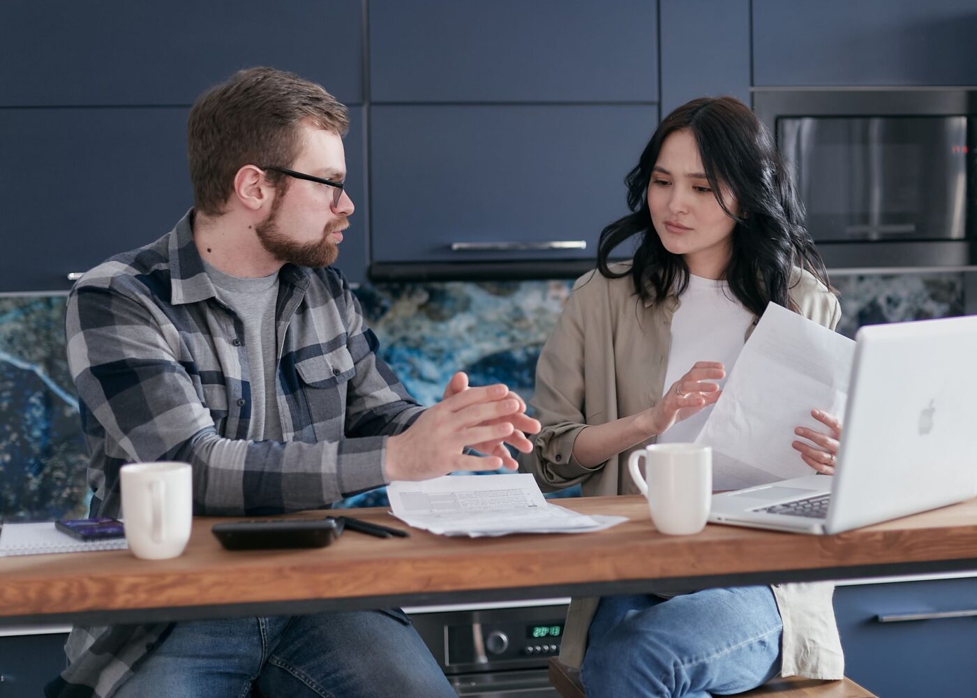 Young worker reviewing a tax return at a kitchen table to claim the Saver's Credit