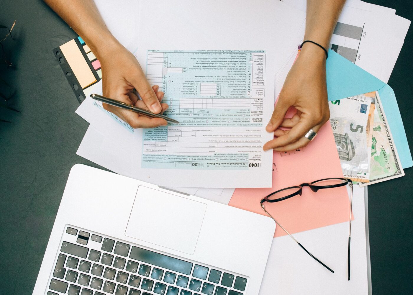 A woman reviews her tax return and refund options at her kitchen table