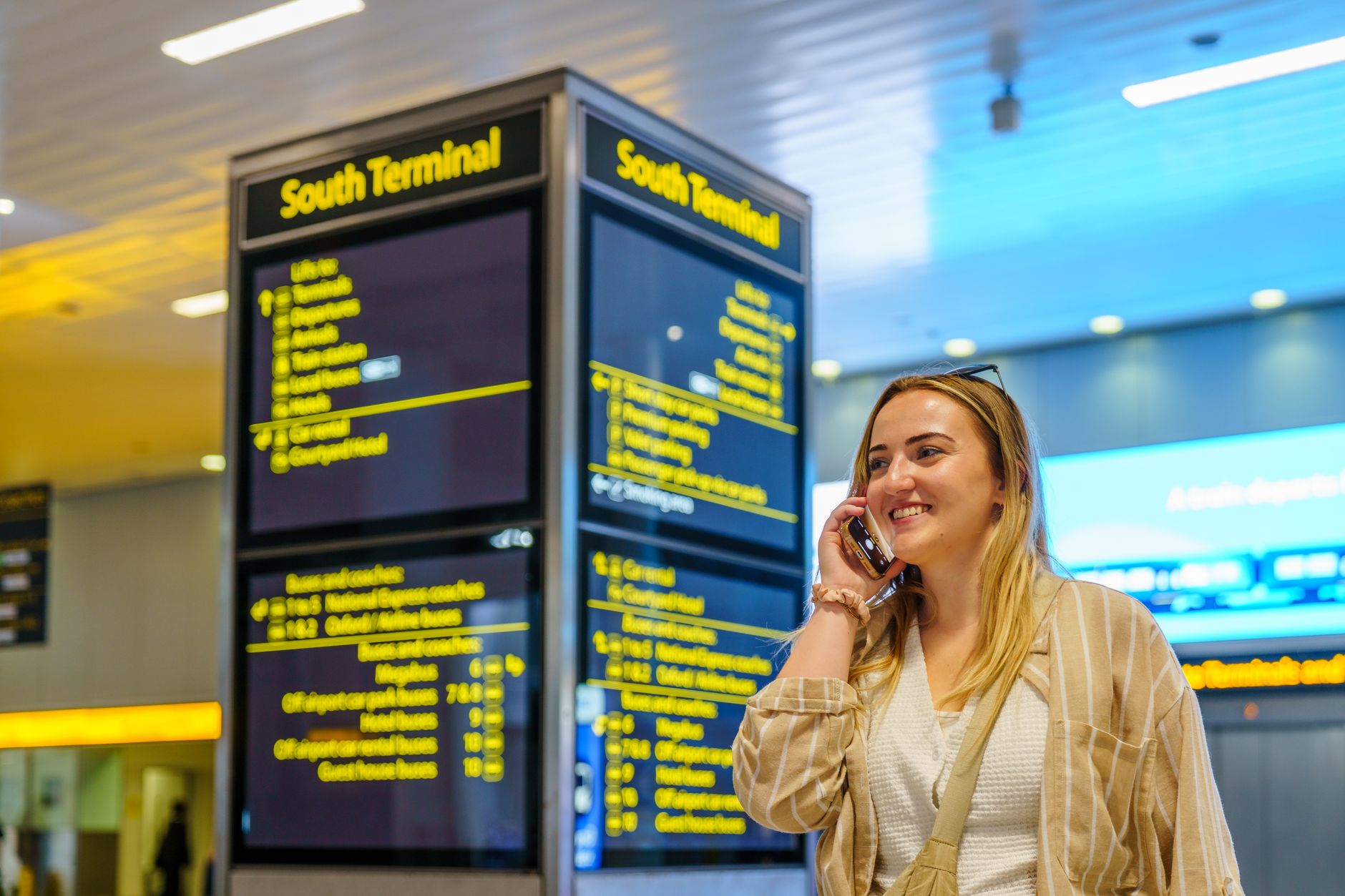 Traveler checking an airport departure board on the way to an out-of-town wedding